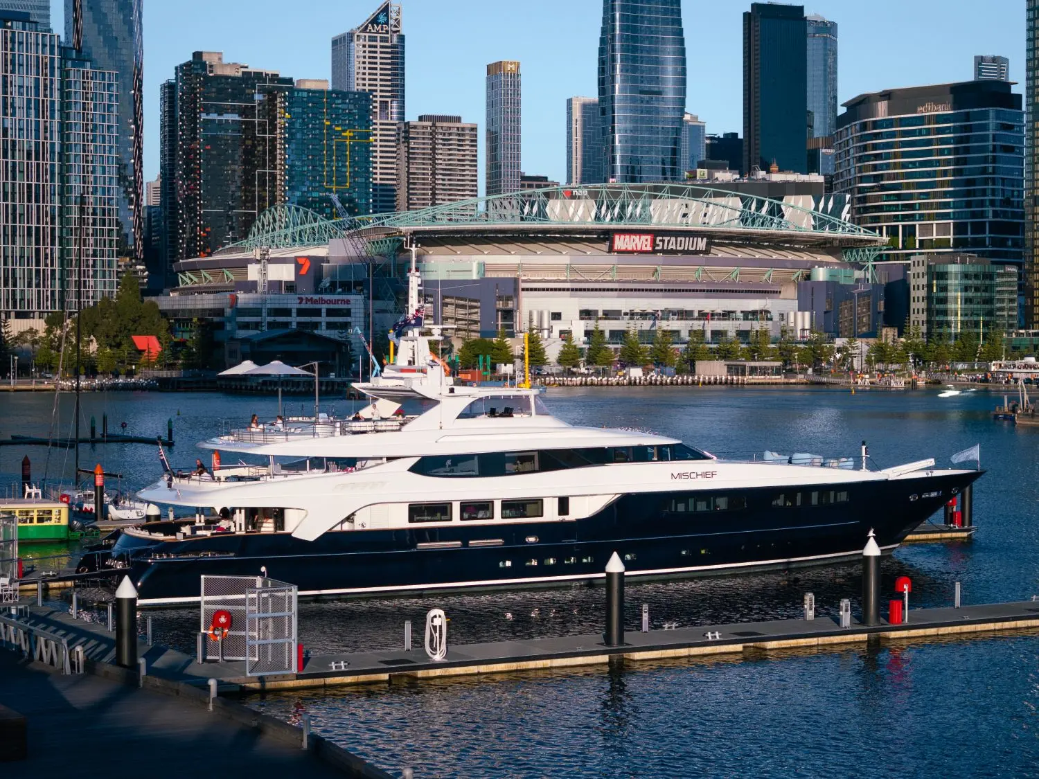 MISCHIEF berthed in Melbourne Docklands in front of Marvel Stadium and the city skyline