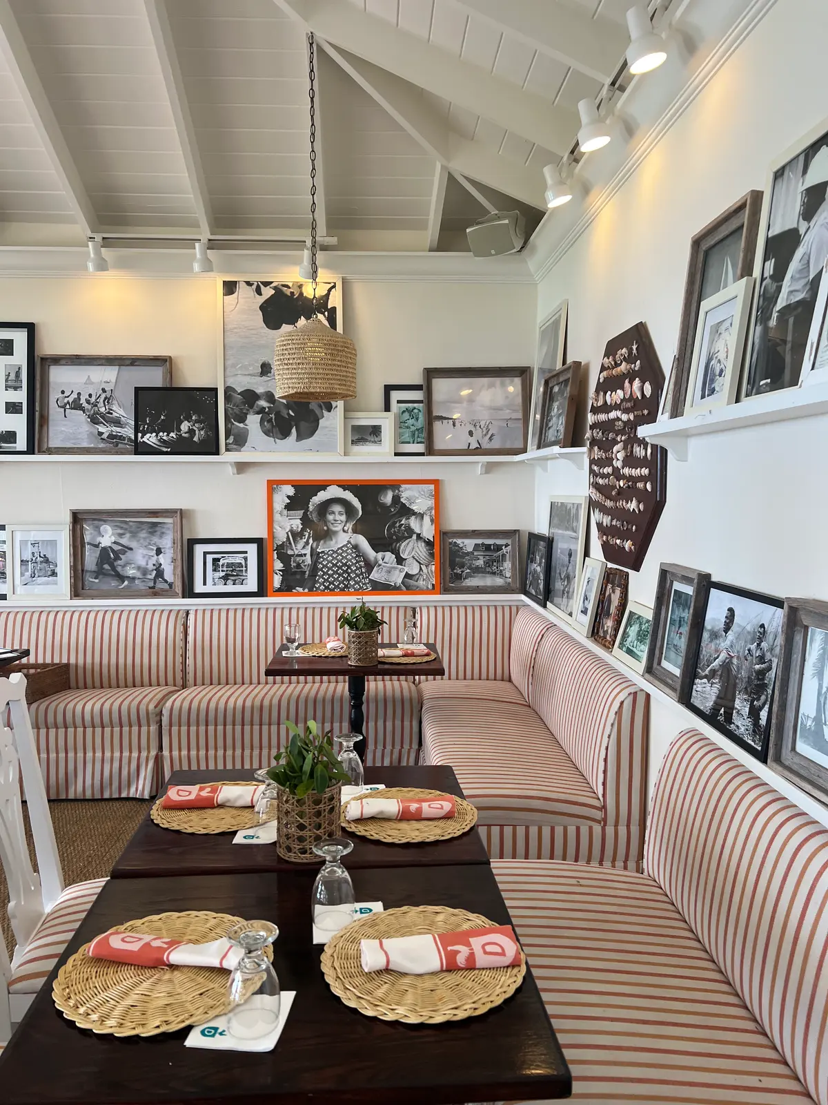 The striped banquettes and photo wall inside the Dunmore