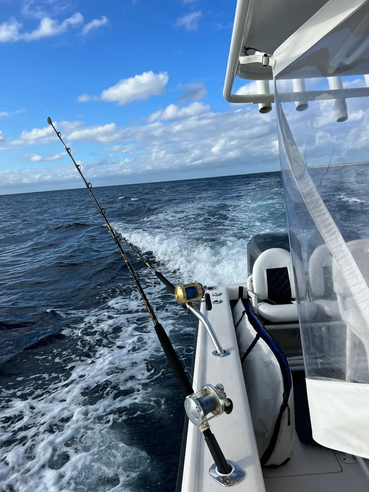 Rods out over the wake on the sport-fishing tender off Nassau