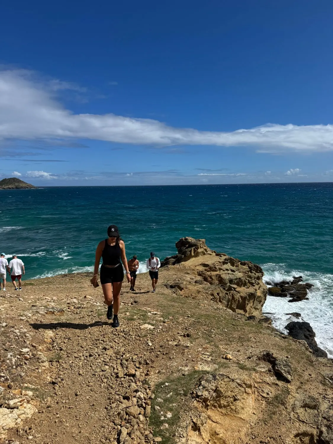 Ellie walking the headland above the sea in St Barths