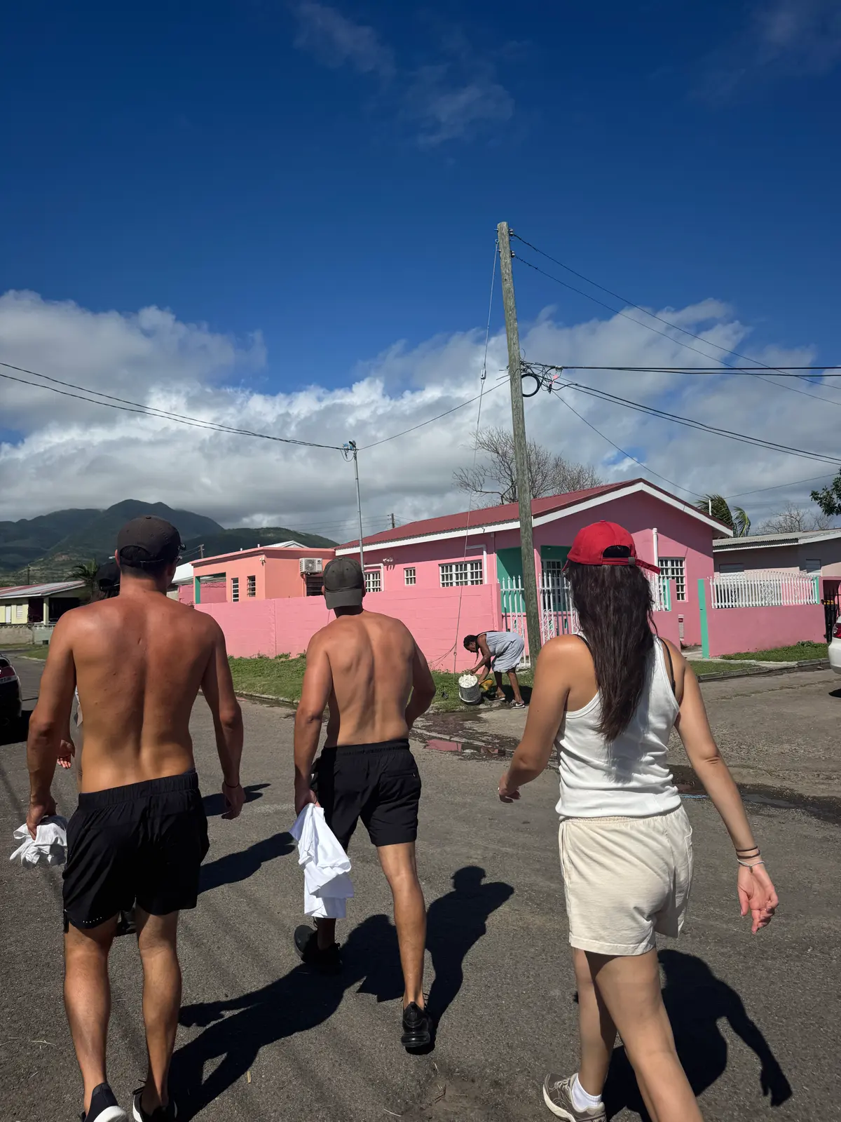 Walking through a St Kitts town, pink houses and the hills behind